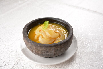 chinese superior double boiled premium shark's fin hot thick soup with crab, prawn and vegetable mushroom with herb in hot stone pot in white background asian halal seafood menu