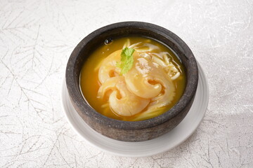 chinese superior double boiled premium shark's fin hot thick soup with crab, prawn and vegetable mushroom with herb in hot stone pot in white background asian halal seafood menu