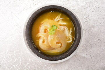 chinese superior double boiled premium shark's fin hot thick soup with crab, prawn and vegetable mushroom with herb in hot stone pot in white background asian halal seafood menu