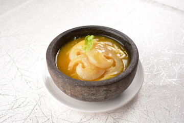 chinese superior double boiled premium shark's fin hot thick soup with crab, prawn and vegetable mushroom with herb in hot stone pot in white background asian halal seafood menu