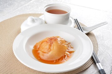 chinese superior double boiled premium shark's fin hot thick soup with crab, prawn and vegetable mushroom with herb in hot stone pot in white background asian halal seafood menu