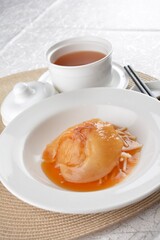 chinese superior double boiled premium shark's fin hot thick soup with crab, prawn and vegetable mushroom with herb in hot stone pot in white background asian halal seafood menu