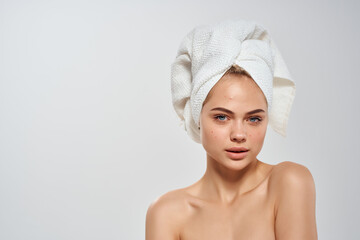 woman with towel on head clean skin health dermatology care