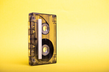 staying vertical vintage audio cassette on yellow background