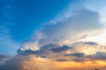 Fototapeta premium Twilight blue bright and orange yellow dramatic sunset sky in countryside or beach colorful cloudscape texture with white clouds air background.