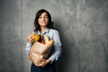 woman with a package of groceries in the supermarket healthy food