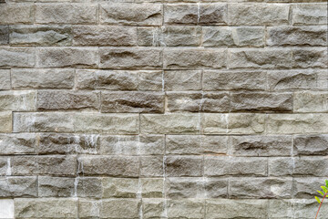 Wall of artificial stone walls, seamless texture on concrete. Beige and brown tone material. New in construction. Artificial stone imitates a brick wall. seamless texture.