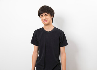 Handsome hipster young boy wearing casual shirt making funny face standing on white background.