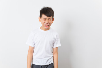 Asian boy wearing white t-shirt with funny face isolated on white background.