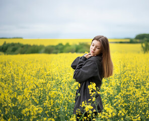 Young girl on yellow rapeseed field