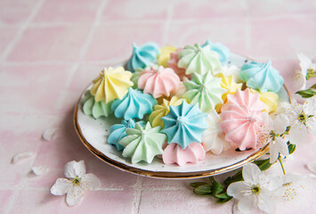 Small colorful meringues in the ceramic  plate
