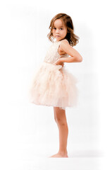 Portrait of happy pretty curly little girl standing and posing over white background