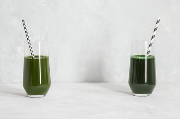 Chlorella and spirulina drinks on a gray background. Healthy detox green drink. Natural supplement with algae. Space for text.