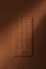 Background of a chocolate bar with cocoa powder