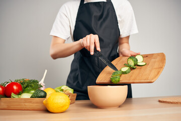 cooking salad with fresh vegetables slicing in the kitchen