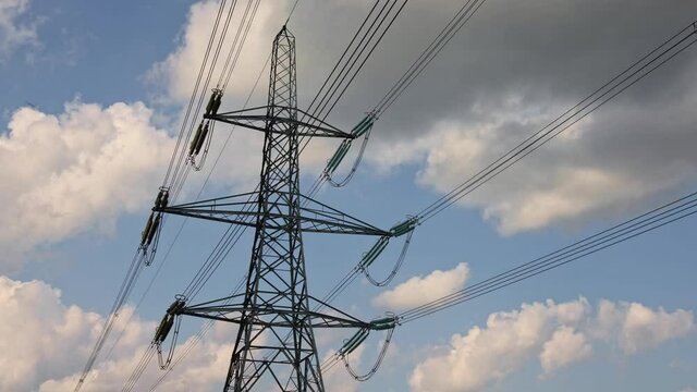 Electricity pylon with clouds and blue sky time lapse. 4k Hertfordshire UK. 