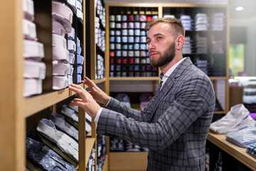 Male customer looking for classic shirts in an elite store