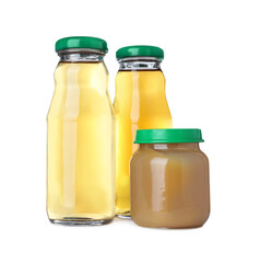 Baby food in jar near bottles of juice on white background