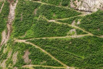 Winding mountain path top view. Walking path for the descent