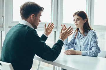 business man and woman at the table communication to work colleague