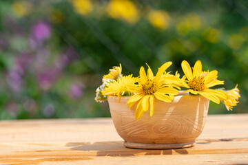 beautiful bouquet of yellow flowers on a wooden table. dandelions. postcard congratulations on the holiday