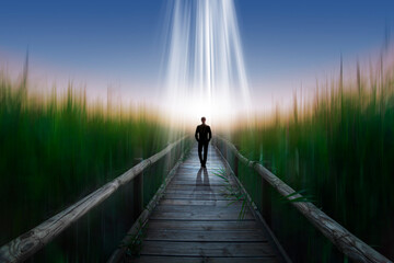 Man walking alone towards the light