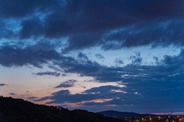 Gloomy rain clouds at sunset.