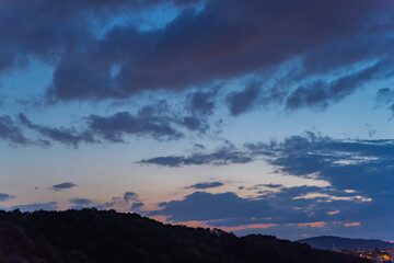 Gloomy rain clouds at sunset.