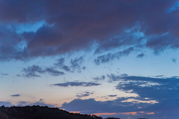 Gloomy rain clouds at sunset.