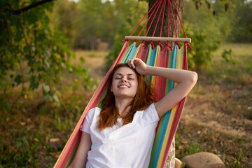 Fototapeta premium joyful woman in nature lies in a hammock rest Comfort