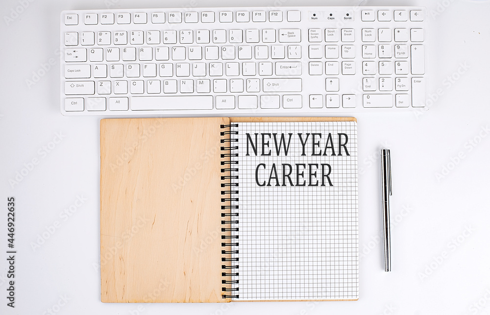 Aufkleber new year career text on the notebook with keyboard on white background