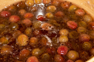 Gooseberry jam is cooked in a bowl in sugar syrup.