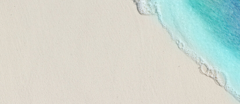 Tropical beach background with sea waves, white sand - summer holiday background. Travel and beach vacation, copy space for text.