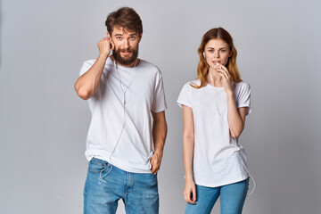 young couple listening to music in white t-shirts fun