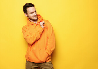 young man posing over yellow background