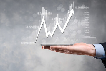 Businessman hold sales data and economic growth graph chart. Business planning and strategy. Analysing trading of exchange. Financial and banking. Technology digital marketing.Profit and growing plan.