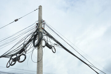 messy electrical wires and communication wires cable on street lamp post in the city,selective...
