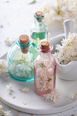 Fototapeta na wymiar Special flower aromatherapy for body care. Lilac flower products.