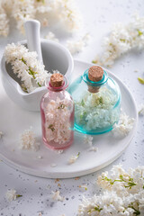 Special glass with flower lilac oil. Lilac flower products.