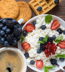 Cottage cheese, coffee, Pancakes for breakfast with blackberries and strawberries. Flat lay.