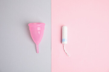 Menstrual cup and tampon on color background, flat lay