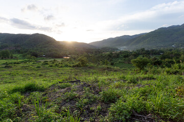 mountain landscape sky village and agricultural land on the hill