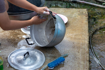 selective focus pot woman washing pot with dishwashing liquid Cleaning kitchen utensils with dishwashing liquid