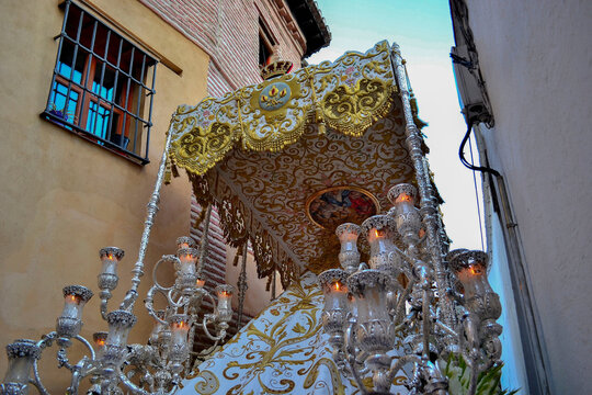 Virgin de la Aurora de Granada in procession through an extremely narrow street with public on the balconies
