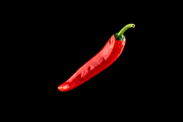 Chilli pepper isolated. Red hot chili paprika or spicy chile cayenne pepper isolated on black background. Ingredient for fresh spice mexican food.