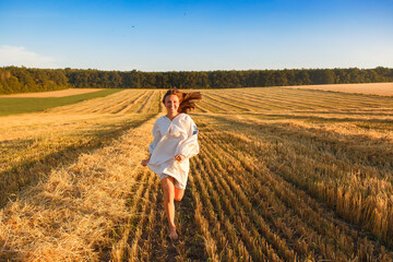 Girl in a wheat field at sunset