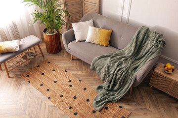 Living room interior with stylish rug and furniture, above view © New Africa