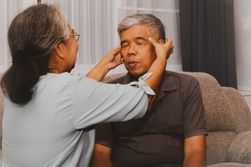 Retired couples take care of their health concept : Wife massages her husband's head to reduce stress and stimulate the circulatory system to nourish the brain better.