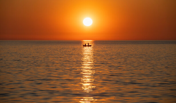 idyllic picture of fishing boat against the setting sun in Rovinj