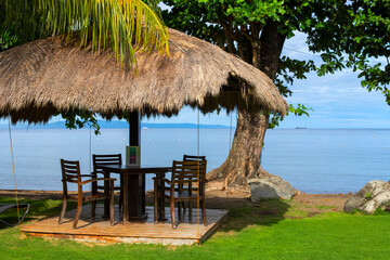 Beach resort facility empty closed for lockdown. Natural palm leaf gazebo on Philippine island....